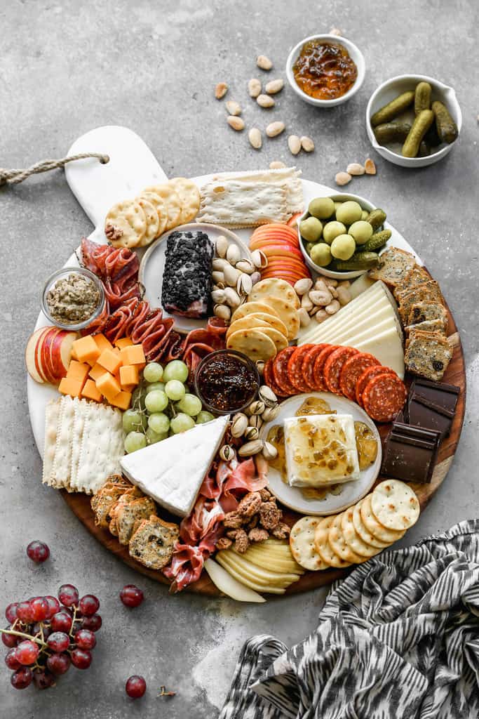 Charcuterie board with cheese, fruit, and crackers